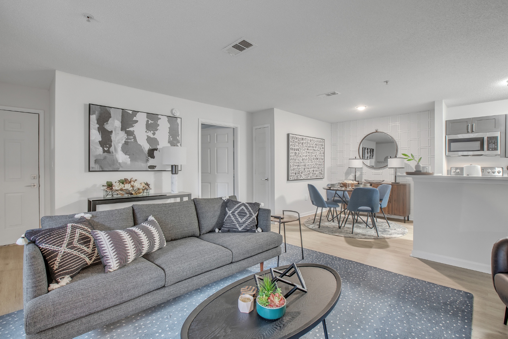 Bright open-concept living room and kitchen at The Aria